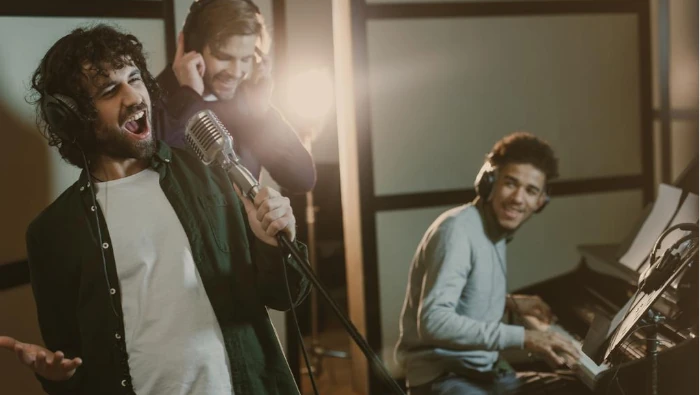 guys singing at recording studio