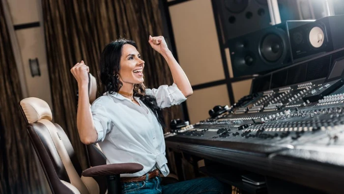 woman happy with recording studio equipment