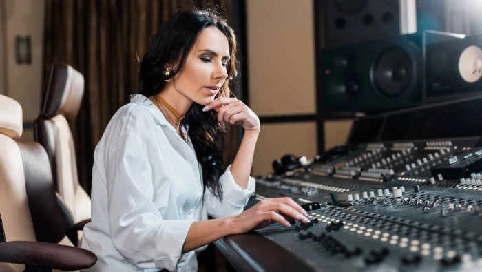 woman mixing audio in a console