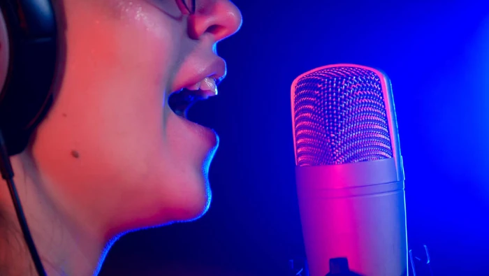 woman singing in front microphone at night