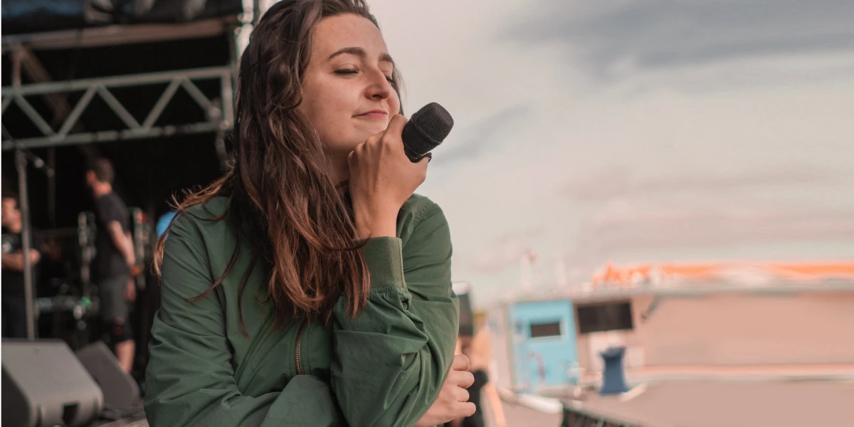 Woman trying to Sing Better in Front of a Big Audience