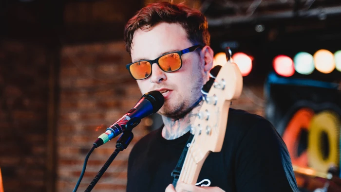 singer singing on stage in front of microphone