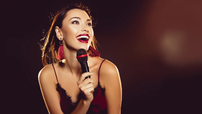 girl singing with a brown background