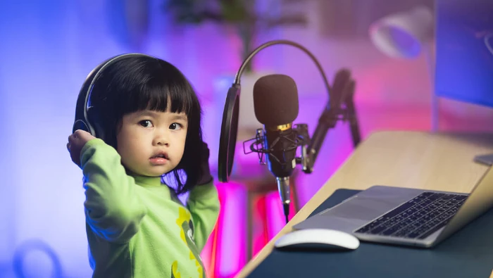 little girl tinkering with a recording studio