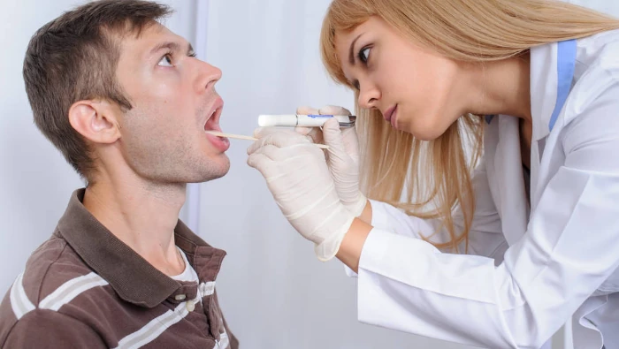 Nurse examining a throat