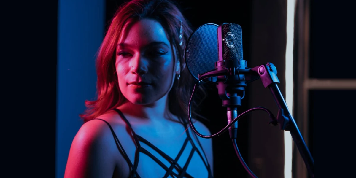 woman singing in a studio microphone