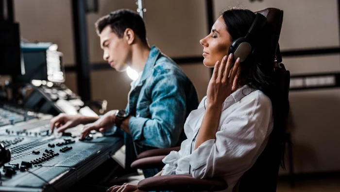 music producers working on a mixing console