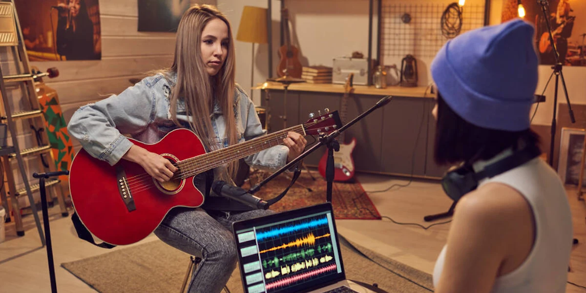 woman recording acoustic guitar at home studio
